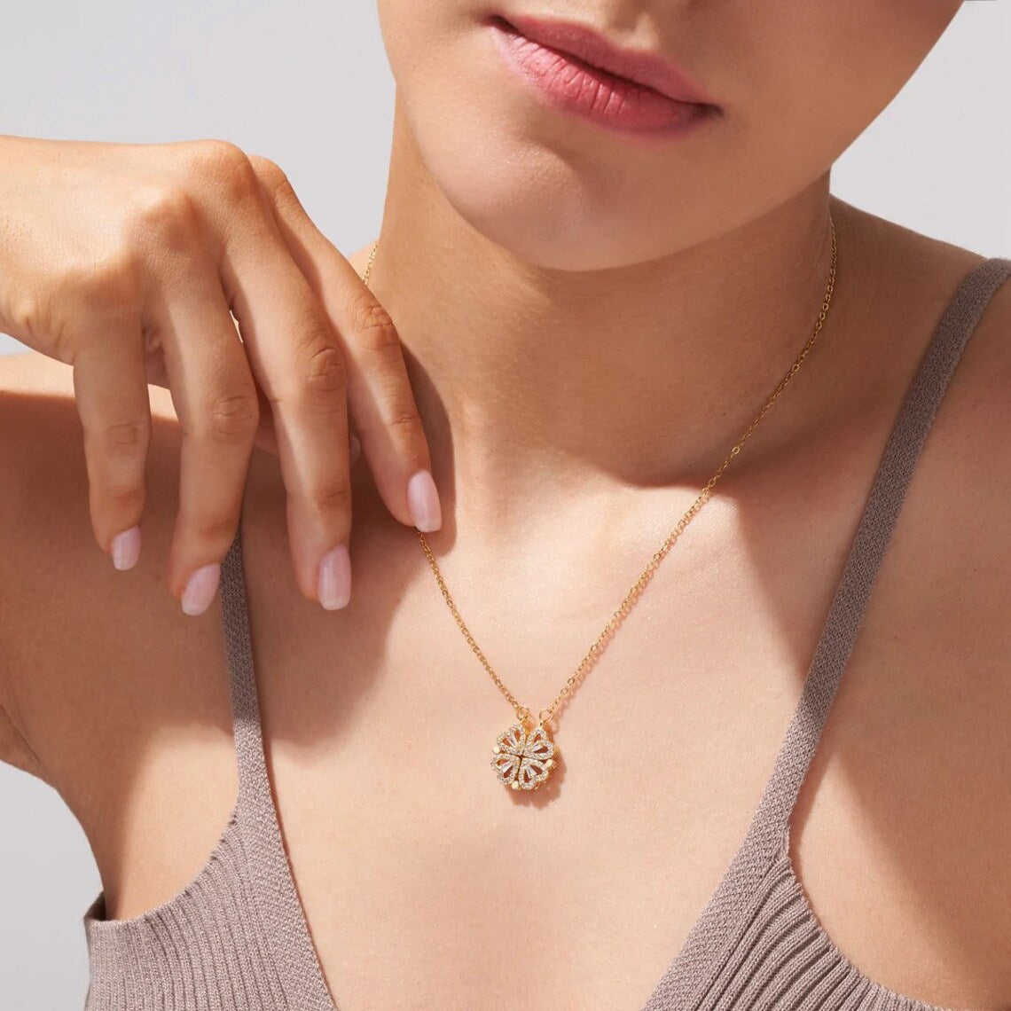 Gold necklace worn with a grey top